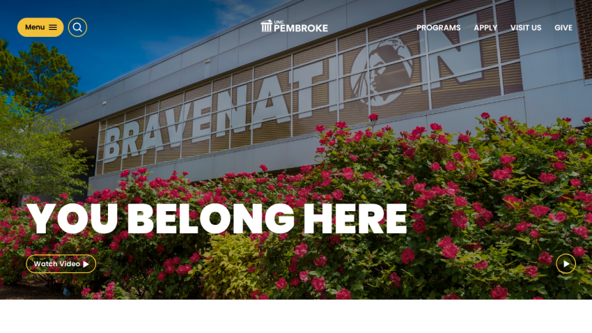 Homepage featuring 'You Belong Here' with vibrant flowers and a building backdrop.