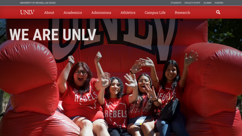 Students celebrating with 'WE ARE UNLV' banner in the background.