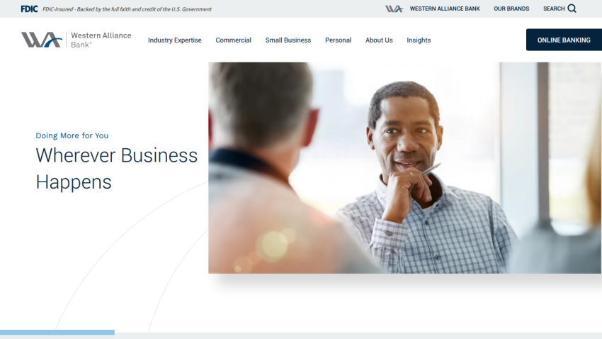 Homepage of Western Alliance Bank featuring a man in conversation with the text 'Wherever Business Happens'.