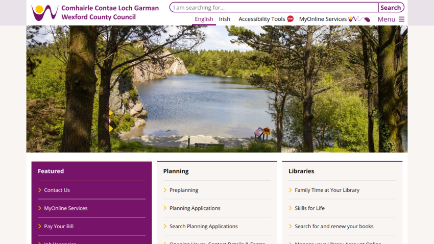 Wexford County Council homepage with search bar, navigation links, and a scenic lake view hero image