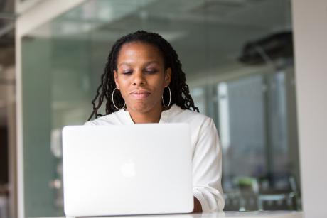 A woman working on macbook
