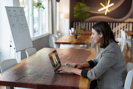 Women working on silver Macbook