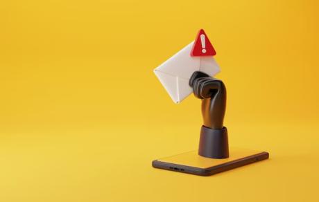 A hacker's hand holding envelope with spam icon on it