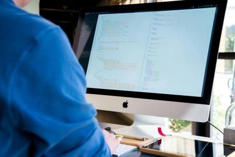 Someone working on an iMac. Photo: Lee Campbell/Unsplash