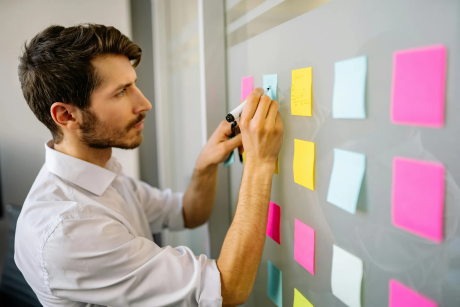 Man writing on sticky notes