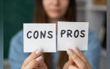 Blurry woman holds pros and cons post-its