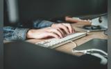 Person typing on keyboard