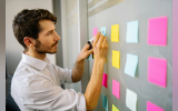 Man writing on sticky notes